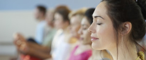 Profile of woman with eyes closed, in group