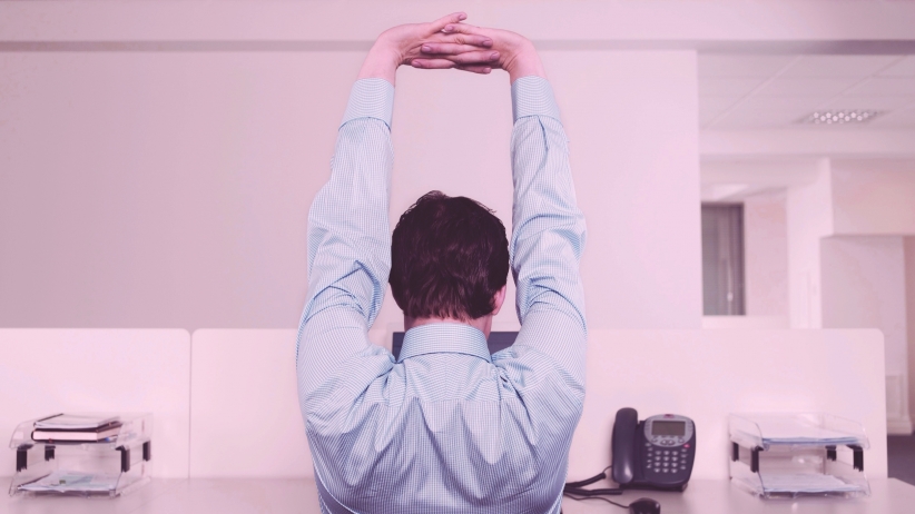 9 Yoga Poses You Can Do At Your Desk Without Looking Really Weird