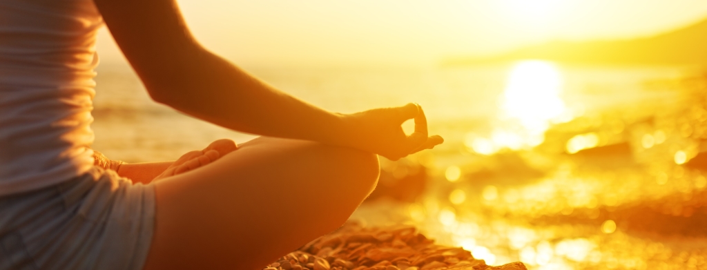 hand of  woman meditating in a yoga pose on beach