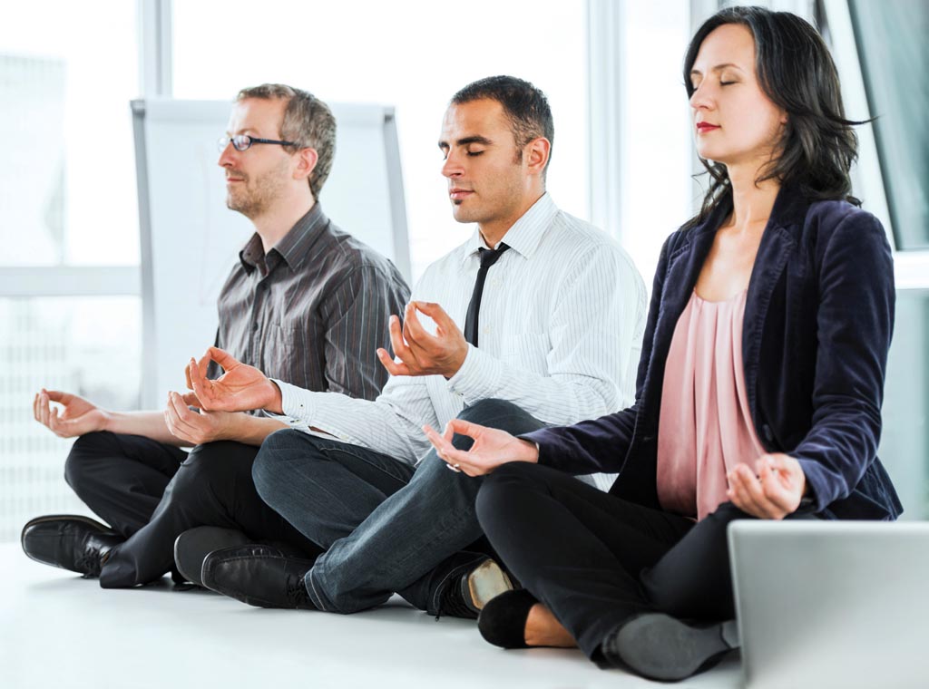Businesspeople sitting on the desks in lotus position and exercising yoga. The focus is on Hispanic man. Taken at iStockalypse Berlin. [url=http://www.istockphoto.com/search/lightbox/9786622][img]http://dl.dropbox.com/u/40117171/business.jpg[/img][/url]